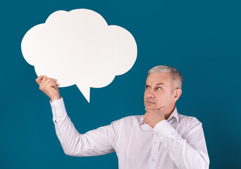 Portrait of elderly man holding speech bubble