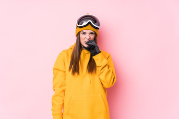 Young caucasian skier woman isolated biting fingernails, nervous and very anxious.