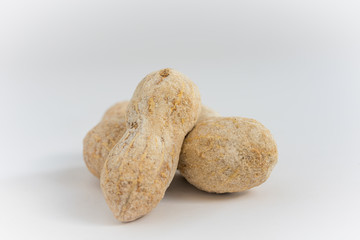 Shelled peanuts close-up on a white background.