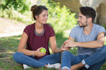 romantic young couple sharing an apple