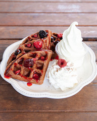 Chocolate waffle with mix berries and soft serve ice cream