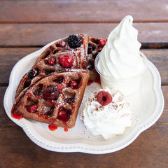 Chocolate waffle with mix berries and soft serve ice cream