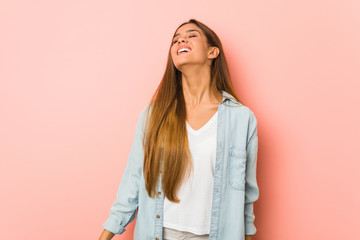 Fototapeta premium Young slim woman relaxed and happy laughing, neck stretched showing teeth.
