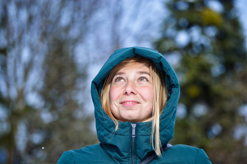 Happy woman smilling during playing with the snow during winter