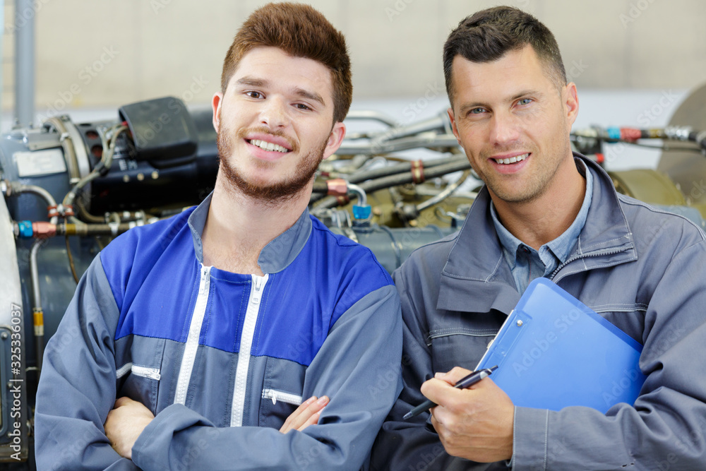 Wall mural father and son work at the auto service