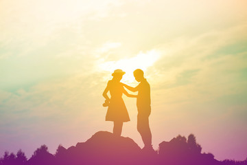 Fototapeta premium Couple enjoying outdoors in a wheat field.