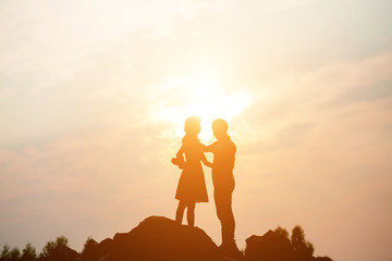 Fototapeta premium Couple enjoying outdoors in a wheat field.