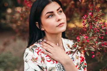 Dreamy woman near blooming tree