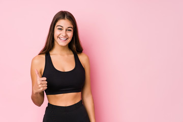 Young caucasian fitness woman doing sport isolated smiling and raising thumb up