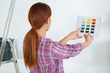 female checking color swatches