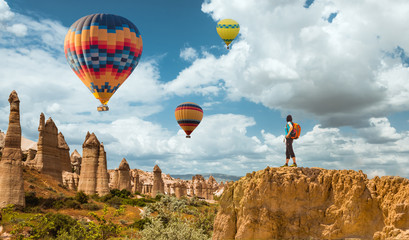 successful sporty woman in Cappadocia with hot air balloons Concept of motion motivation inspiration - obrazy, fototapety, plakaty