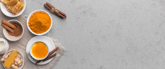 Turmeric in different shapes curcuma powder on gray