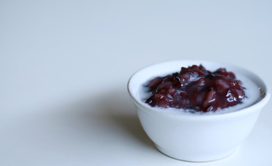 Black glutinous rice porridge or bubur ketan hitam with coconut milk. Indonesian sweet dessert. 