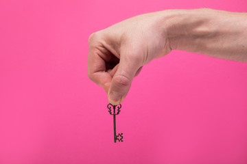 Man hand old key. 