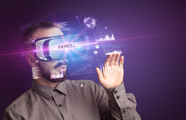 Businessman looking through Virtual Reality glasses with PAYROLL inscription, new business concept