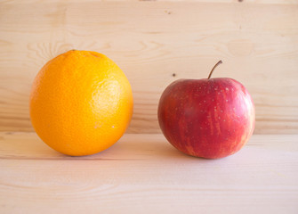 red Sicilian orange and red apple full of vitamins on the wooden background, special Mediterranean diet