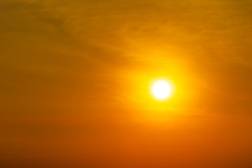 Fototapeta na wymiar The sun on orange sky and clouds nature background