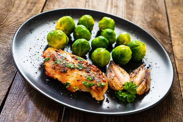 Roast chicken breast and on wooden background 