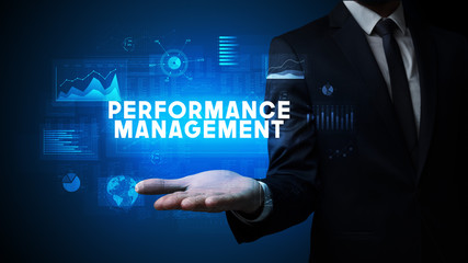 Hand of Businessman holding PERFORMANCE MANAGEMENT inscription, business success concept