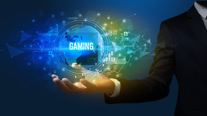Elegant hand holding GAMING inscription, digital technology concept