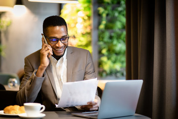 Portrait of black businessman making phone call