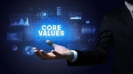 Hand of Businessman holding CORE VALUES inscription, business success concept
