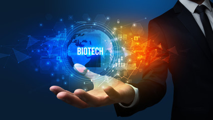 Elegant hand holding BIOTECH inscription, digital technology concept