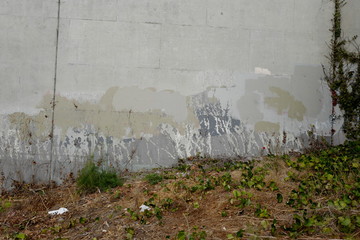old painted wall by some grass and dirt