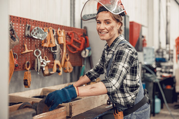 Female worker in a safety helmet looking ahead