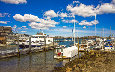 Fototapeta na wymiar Long Wharf with Customhouse Block and yacht in Charles River