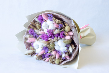 a bouquet of dried flowers of cereals cotton lavender on a white background