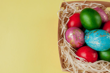 Happy Easter eggs yellow background. Golden shine decorated eggs in basket, for greeting card, promotion, poster. Copy space