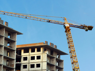 Building under construction. Construction site. Crane near building.