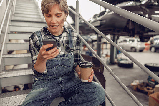 Girl in overalls using her mobile phone