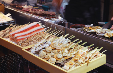 a lot of grilled seafood in wood box