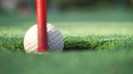 Playing golf and hitting a ball in slow motion 180fps