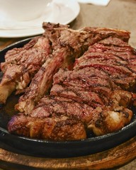 closeup prime rib steak in hot plate