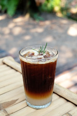 closeup iced americano on bamboo table