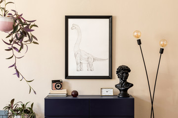 Stylish interior of living room with black mock up poster frame, plants, design lamp, blue navy commode, photo camera and elegant personal accessories. Beige walls. Modern home staging. Template.