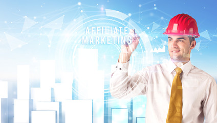 Handsome businessman with helmet drawing AFFILIATE MARKETING inscription, contruction business concept