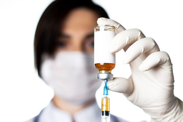 Ampoule and syringe in hands of doctor. Vaccinations or cosmetology concept