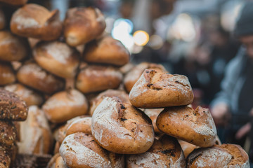 A pile of fresh bread made from whole flour. Crispy, blurred background. The Market, Jerusalem.