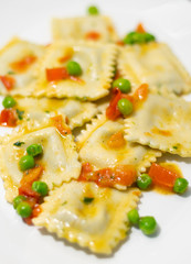 traditional ravioli with tomato and green peas