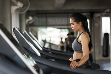 Fototapeta na wymiar woman cardio run on treadmills in gym