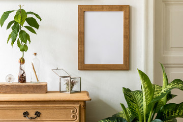 Minimalistic compositon with wooden vintage commode, brown mock up photo frame, avocado plant,...