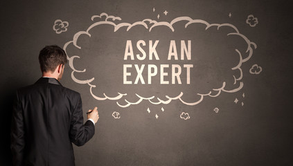 businessman drawing a cloud with ASK AN EXPERT inscription inside, modern business concept