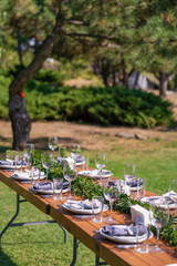 Preparing for an open-air party. Decorated with fresh flowers served tables. Table number. Decoration Details