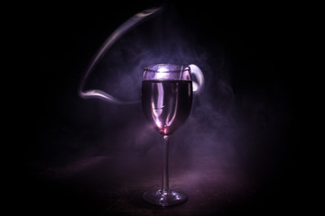 Goblet of white wine on wooden table on wooden wall background