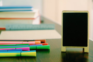 Back to school background with books, pencils colorful on wooden table classroom.
