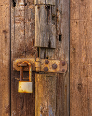 Rusting padlock and old door.